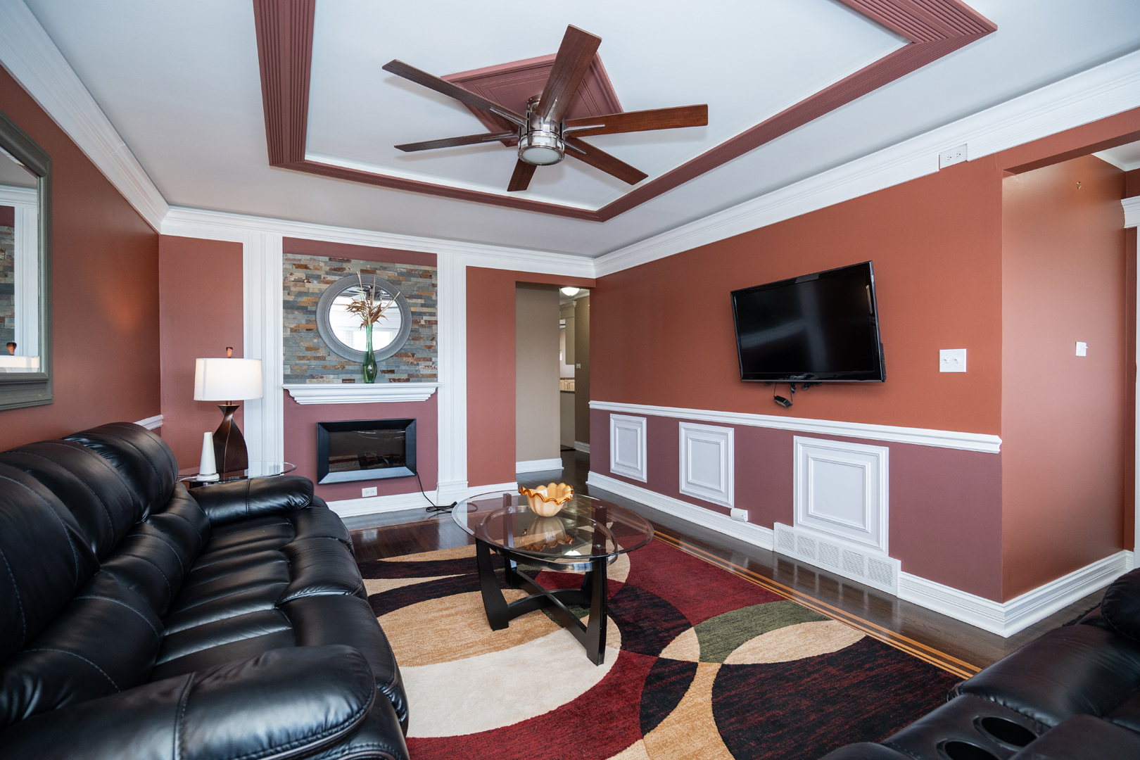 4114 West 79th Place Chicago, IL 60652 - Photo 3 of 30 a living room with furniture a flat screen tv and a fireplace