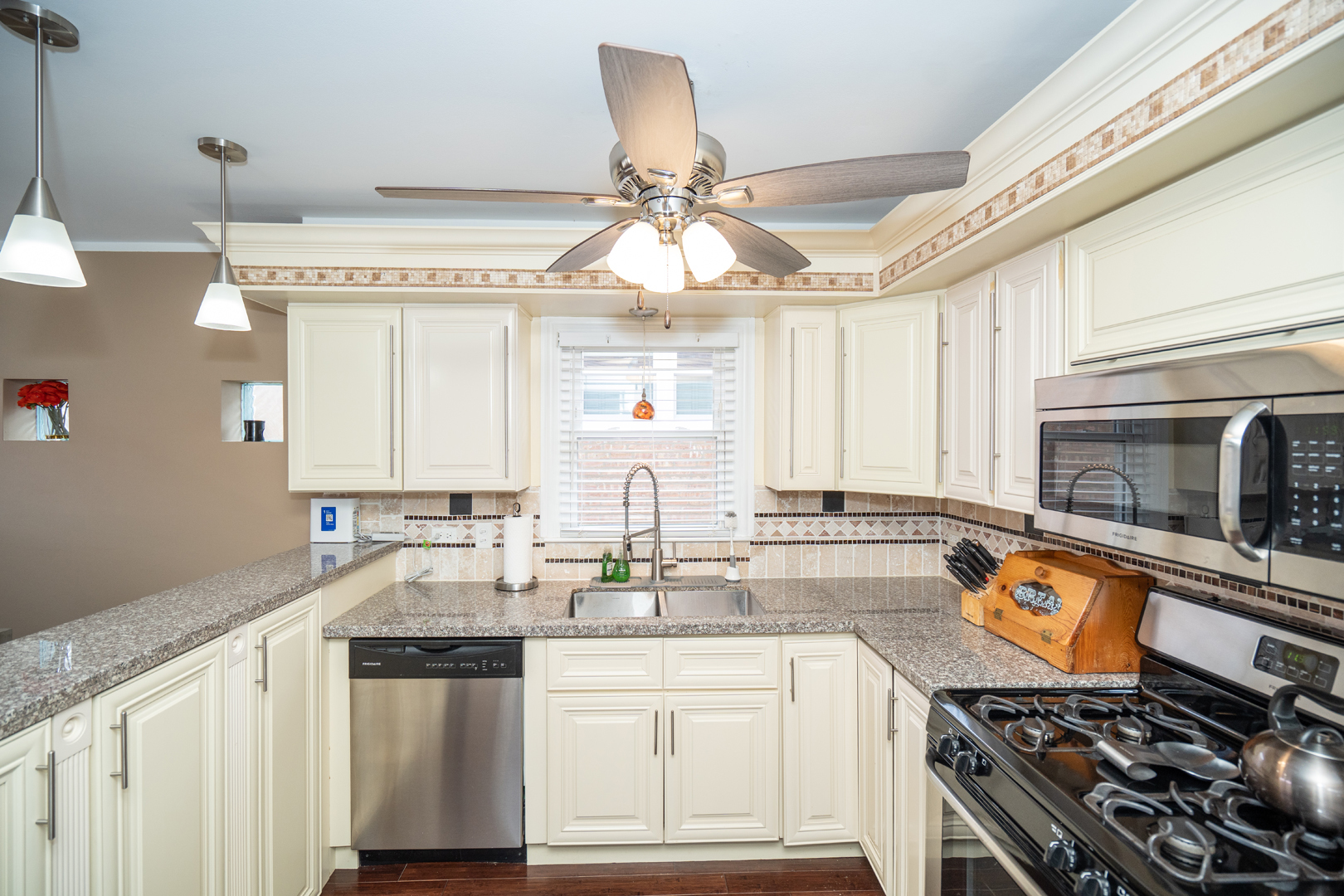 4114 West 79th Place Chicago, IL 60652 - Photo 10 of 30 a kitchen with stainless steel appliances a stove a sink and a microwave