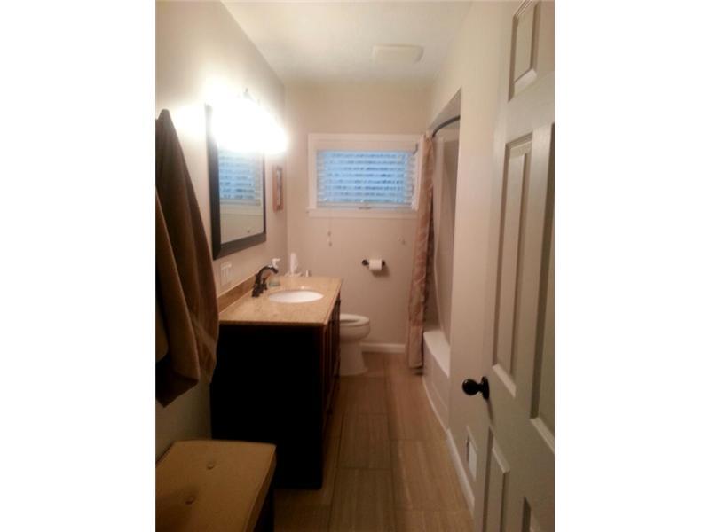 9406 Woodcrest Road Pittsburgh, PA 15237 - Photo 19 of 25 Full Bath. Totally gutted and tastefully redone. Oblong ceramic tile, tub and shower unit, vanity sink. Very shiek