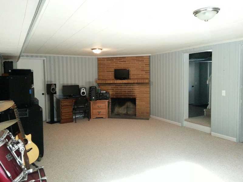 9406 Woodcrest Road Pittsburgh, PA 15237 - Photo 21 of 25 Basement/Game Room. 24 x 14 New carpeting and paint, lighting Brick log-burning fireplace. Door to left has two storage areas; 16x11 and 11x5