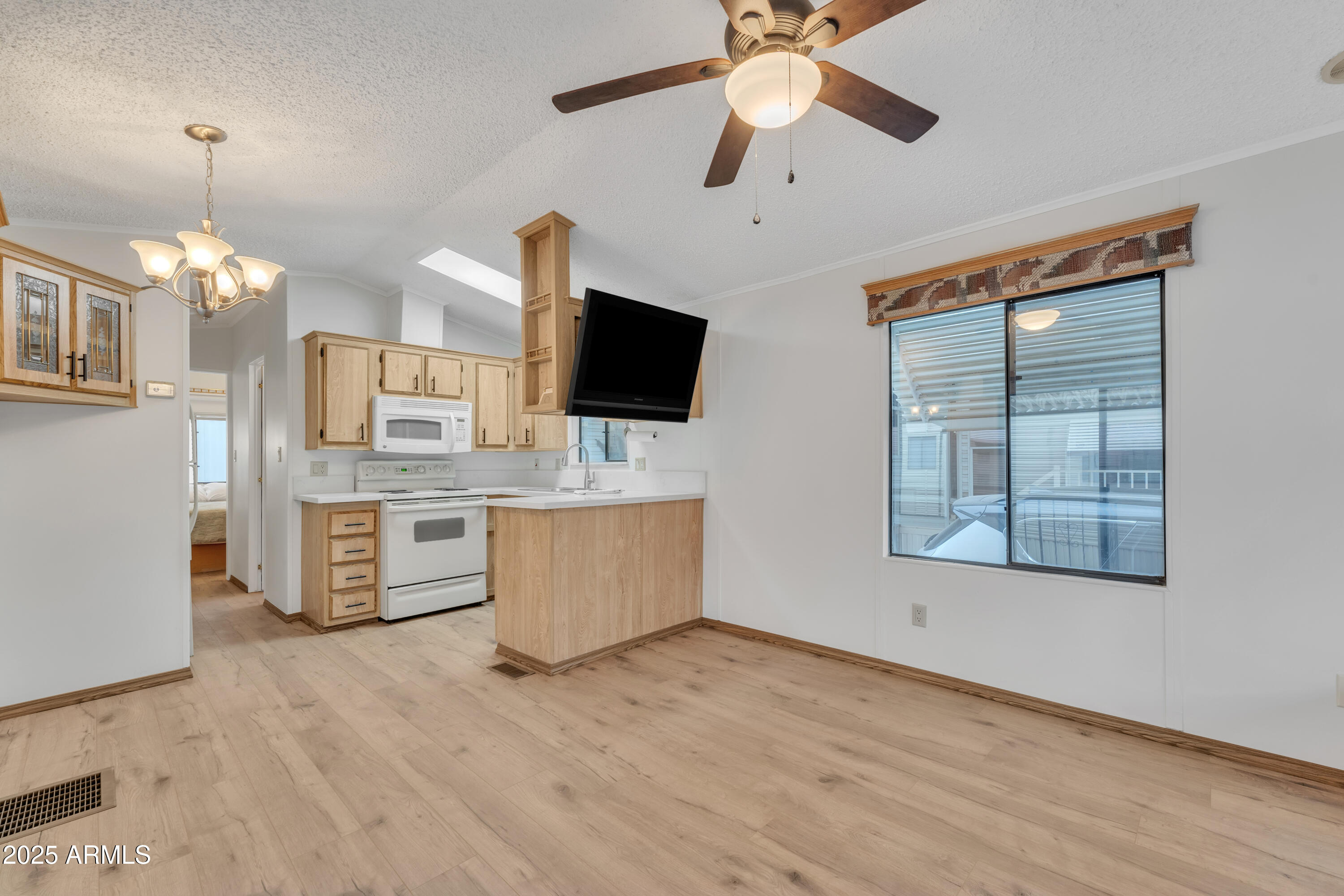 a kitchen with stainless steel appliances kitchen island granite countertop a stove a sink and a wooden floors