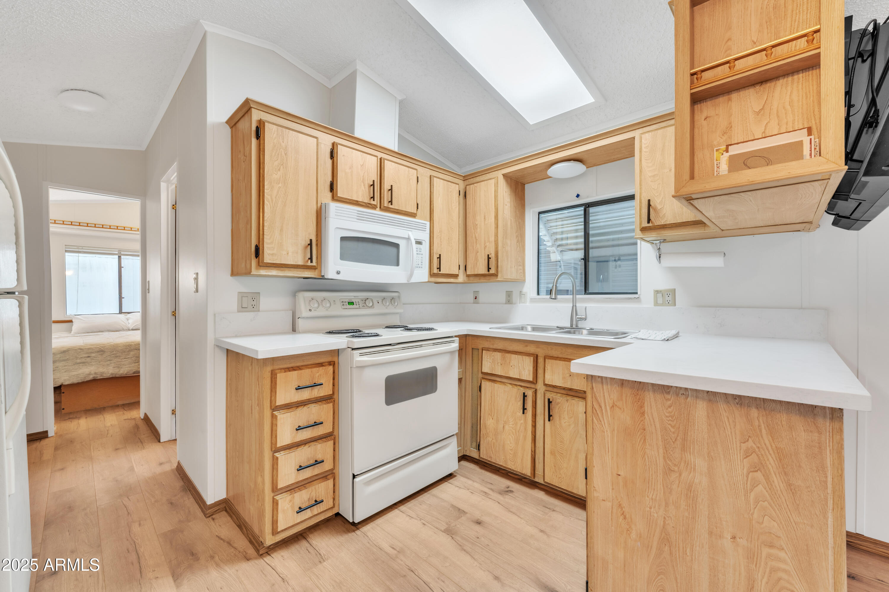 1152 South Sioux Drive Apache Junction, AZ 85119 - Photo 16 of 50 a kitchen with stainless steel appliances granite countertop a sink stove and cabinets