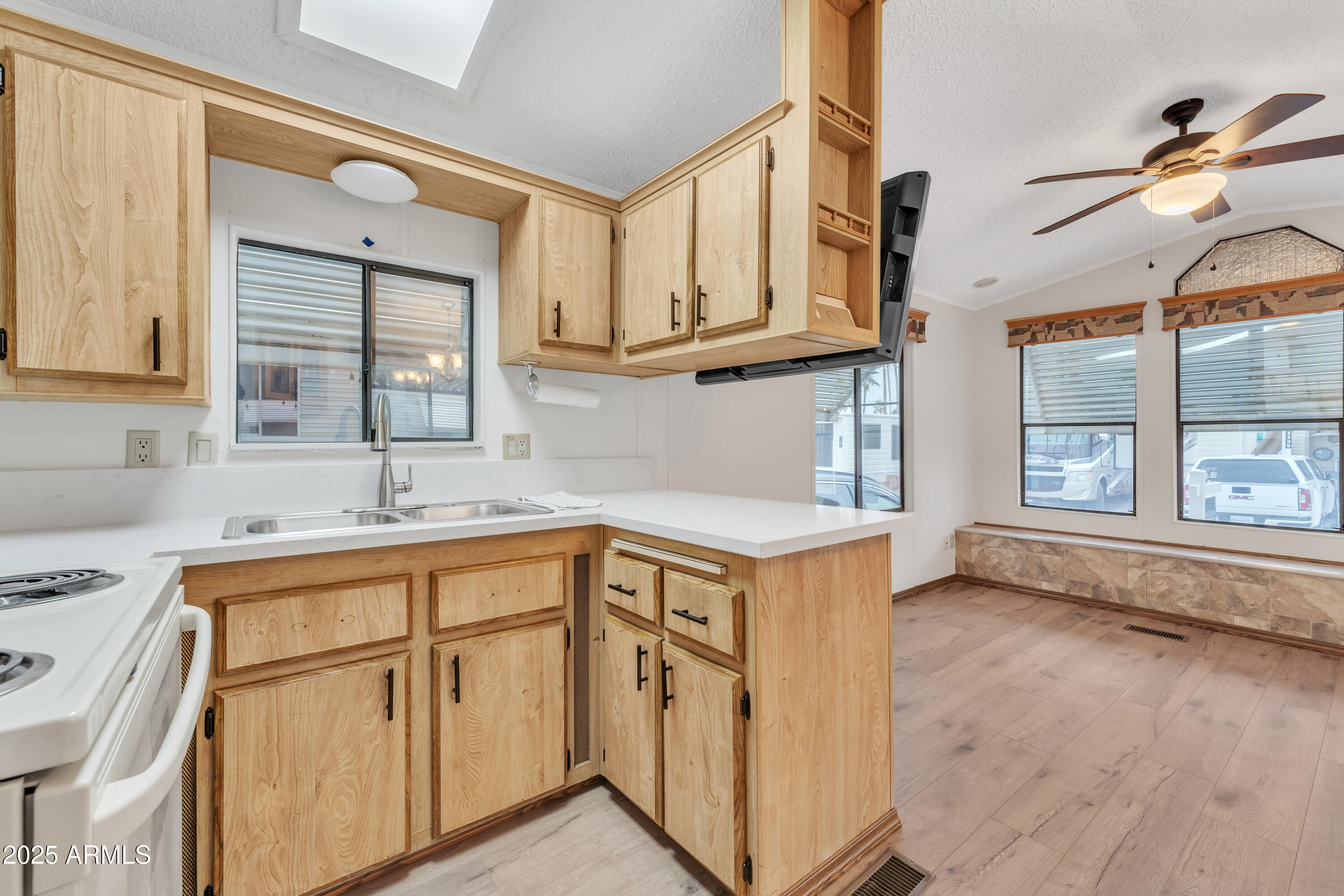 1152 South Sioux Drive Apache Junction, AZ 85119 - Photo 18 of 50 a kitchen with stainless steel appliances granite countertop a sink and cabinets with wooden floor