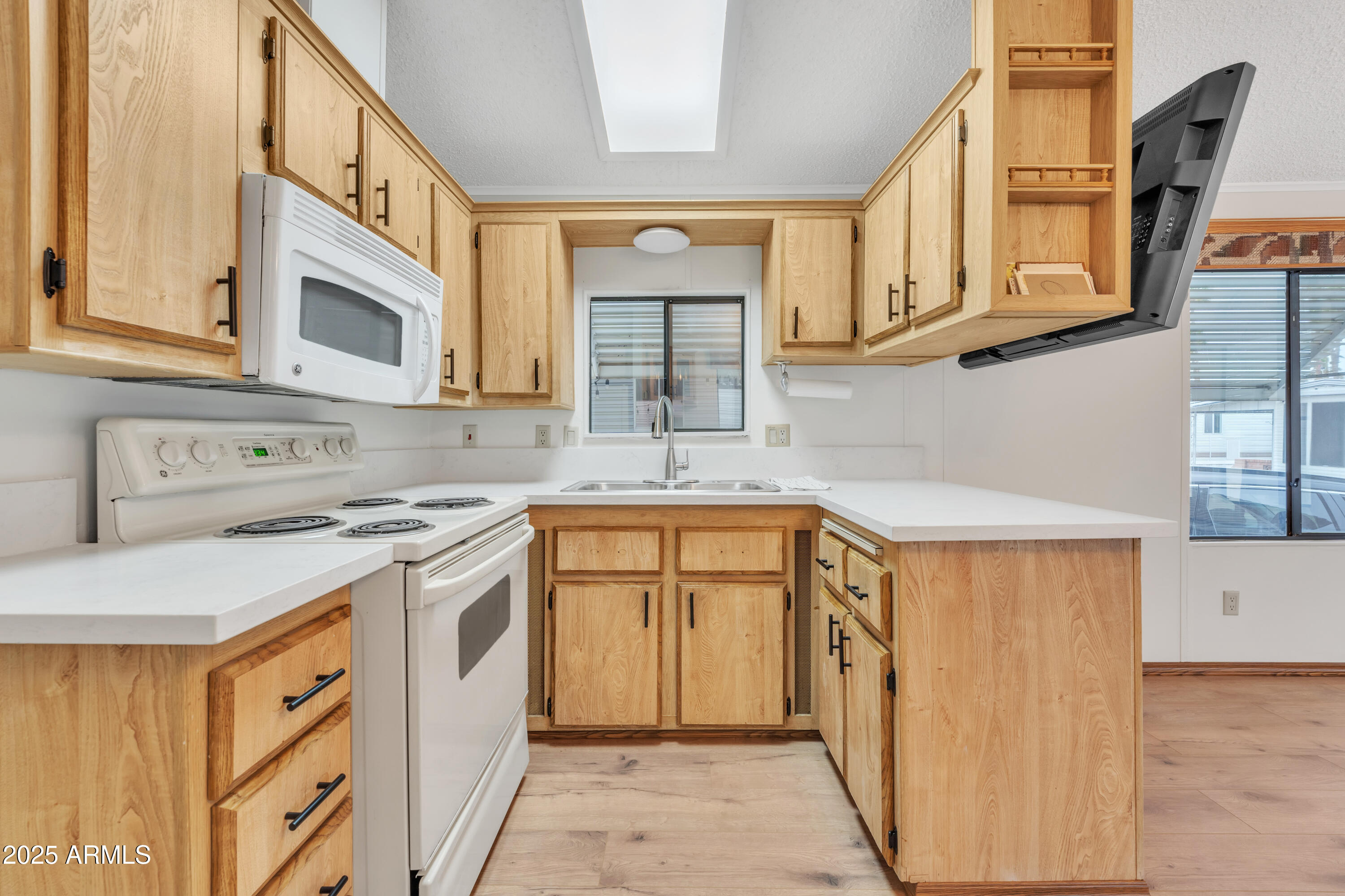 1152 South Sioux Drive Apache Junction, AZ 85119 - Photo 2 of 50 a kitchen with stainless steel appliances granite countertop a sink and cabinets with wooden floor