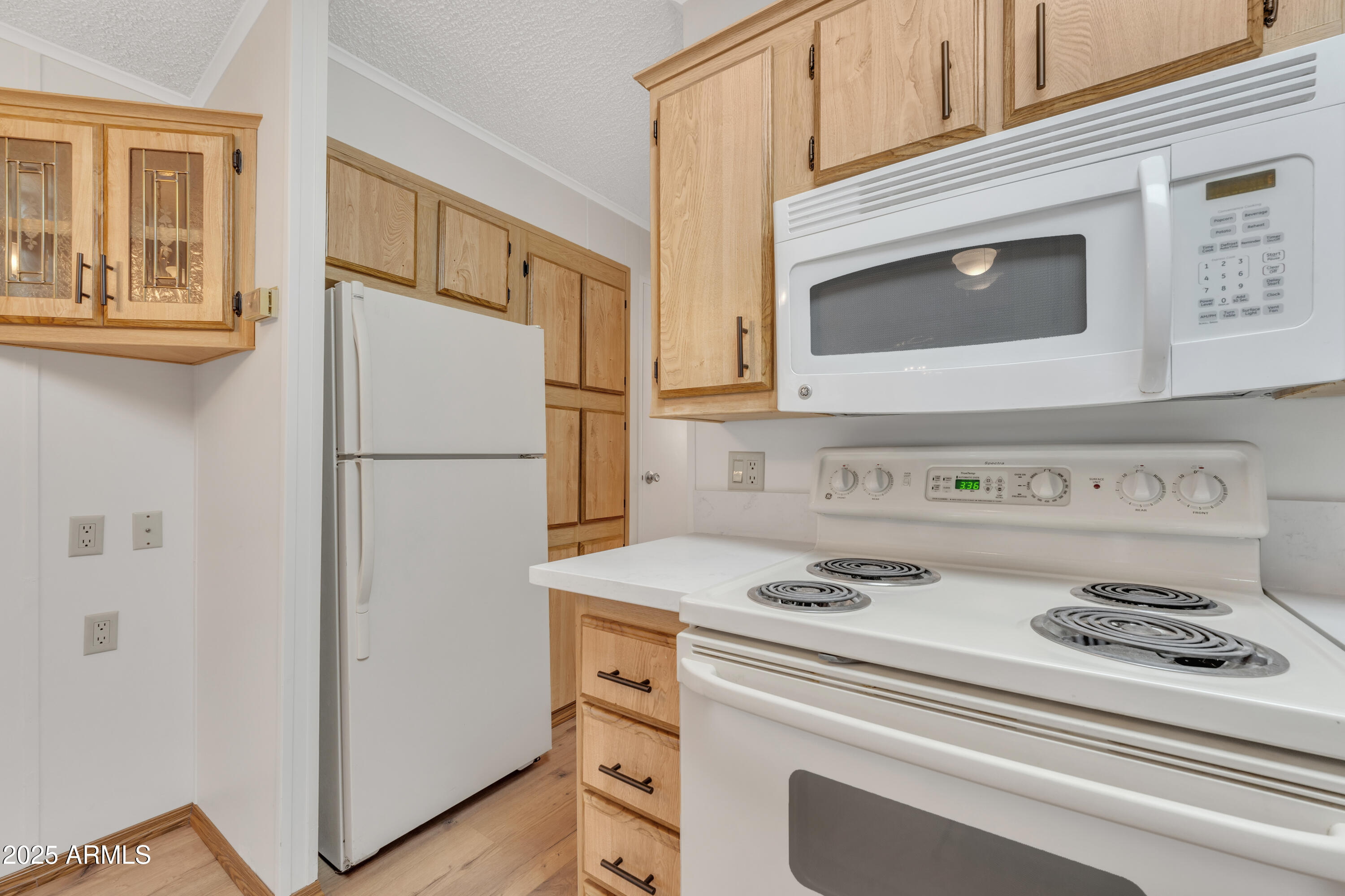 1152 South Sioux Drive Apache Junction, AZ 85119 - Photo 22 of 50 a kitchen with a refrigerator stove and white cabinets