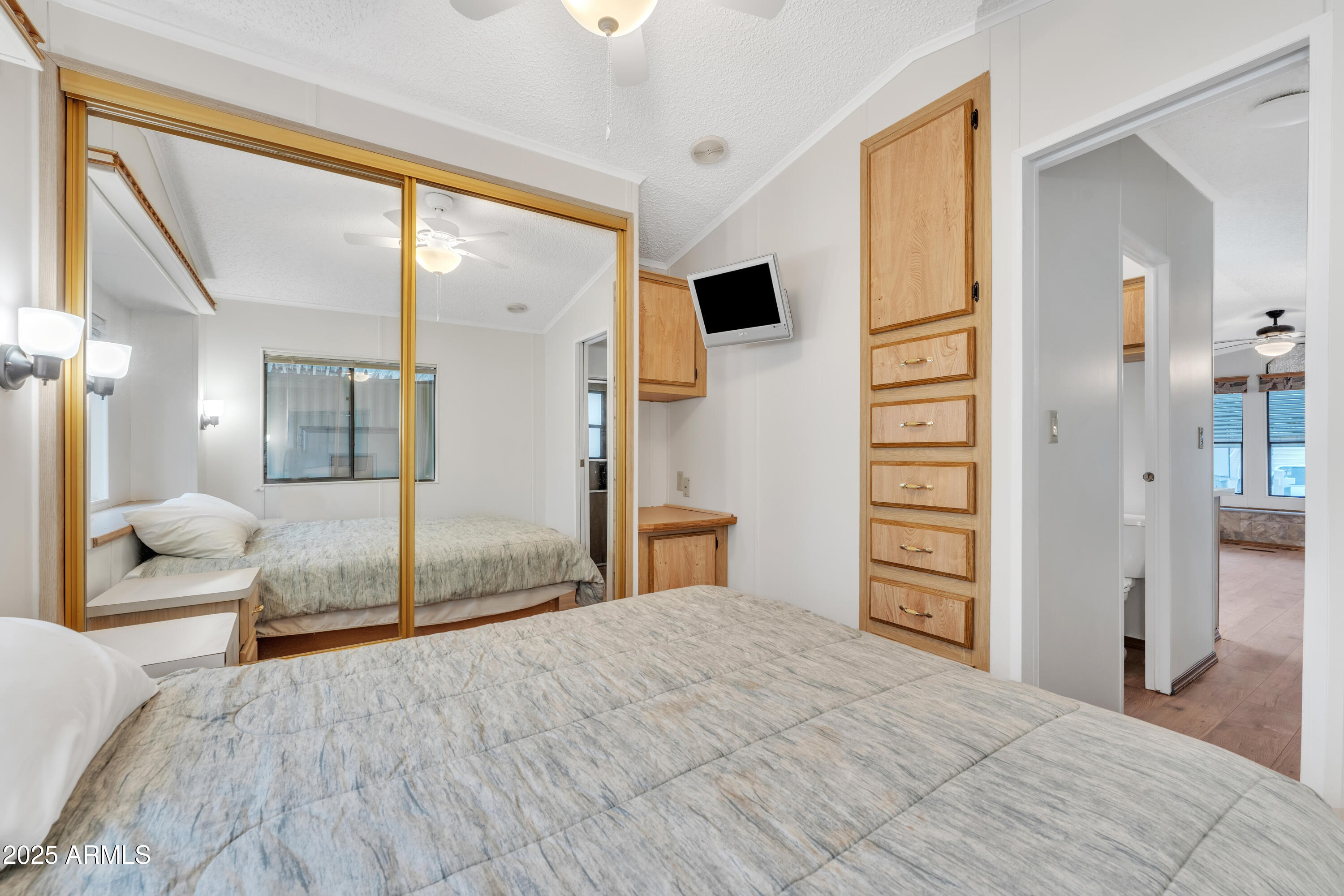 1152 South Sioux Drive Apache Junction, AZ 85119 - Photo 27 of 50 a bedroom with a bed and a large mirror