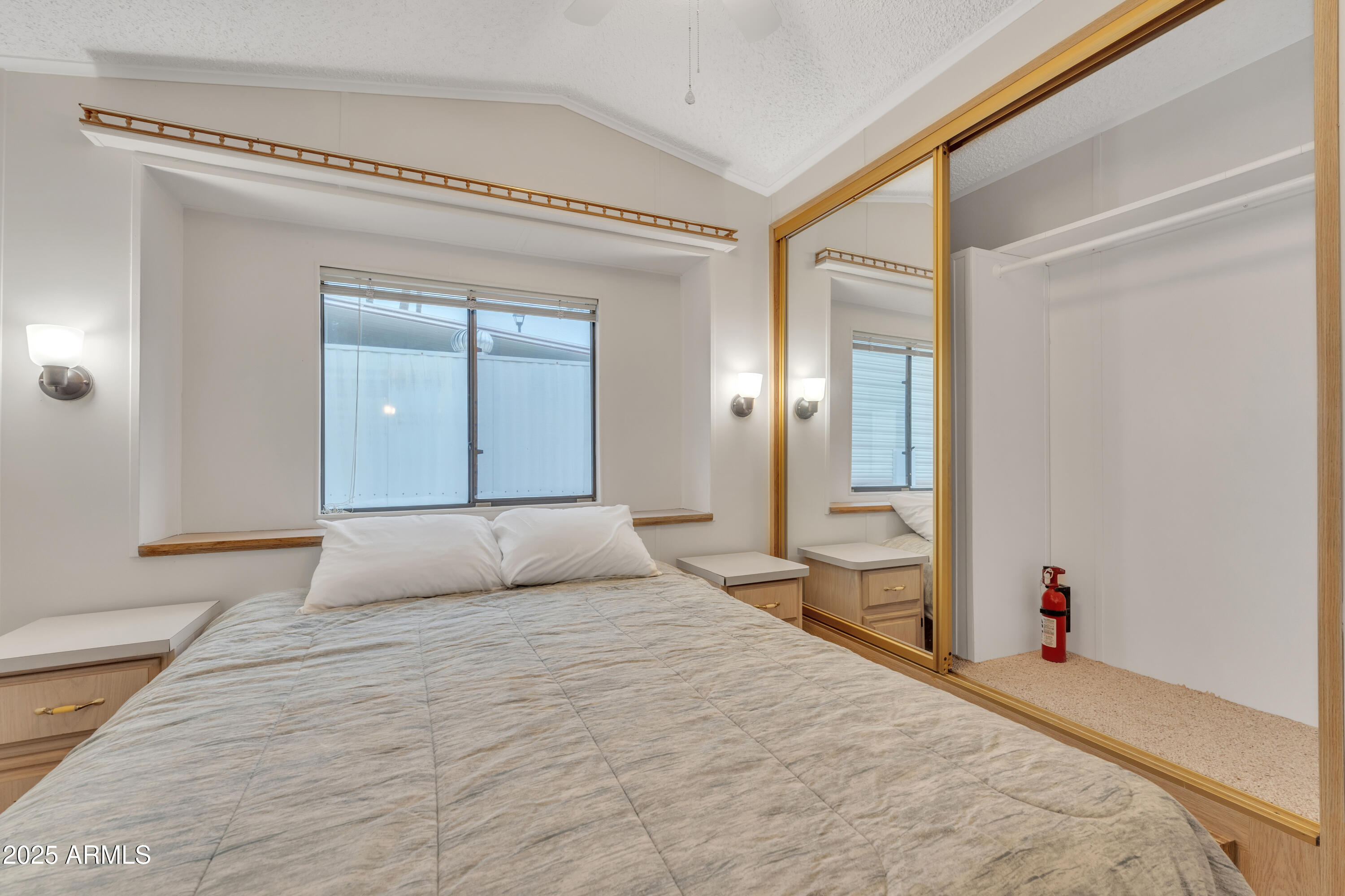 1152 South Sioux Drive Apache Junction, AZ 85119 - Photo 30 of 50 a bedroom with a large bed and a chandelier