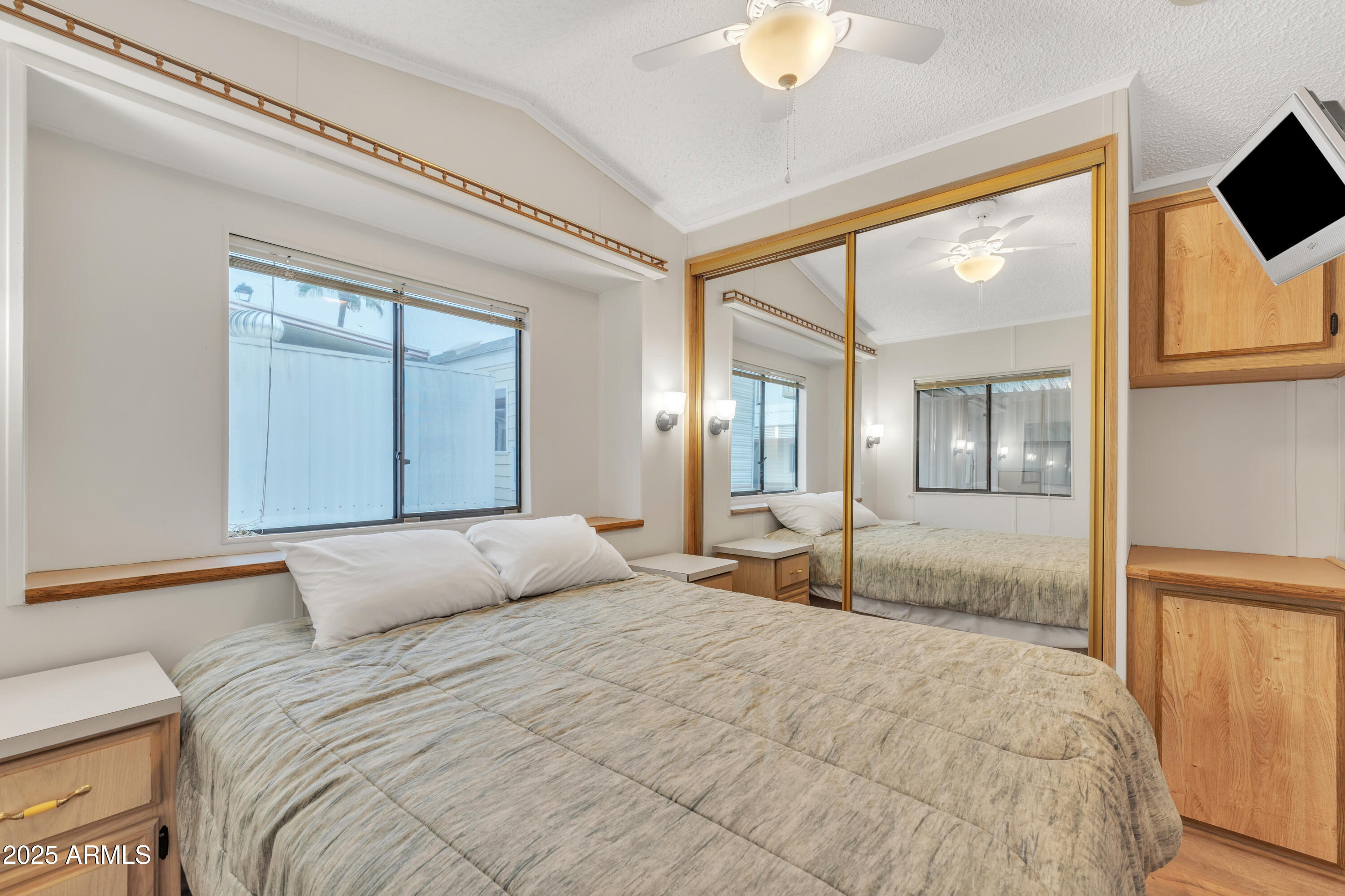 1152 South Sioux Drive Apache Junction, AZ 85119 - Photo 3 of 50 a bedroom with a large bed and a flat screen tv