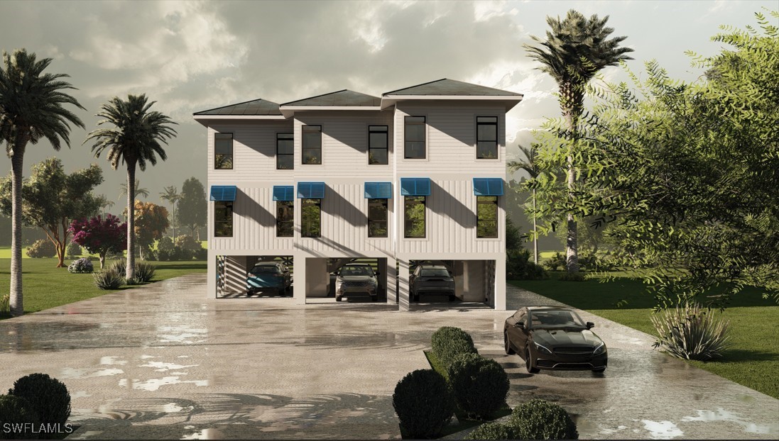 2163-2153 Periwinkle Way Sanibel, FL 33957 - Photo 13 of 37 a front view of a house with a yard