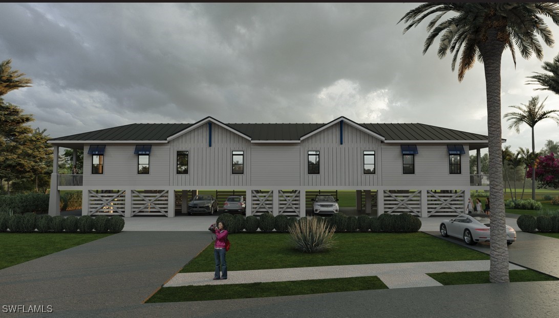 2163-2153 Periwinkle Way Sanibel, FL 33957 - Photo 14 of 37 a front view of a house with a yard and garage