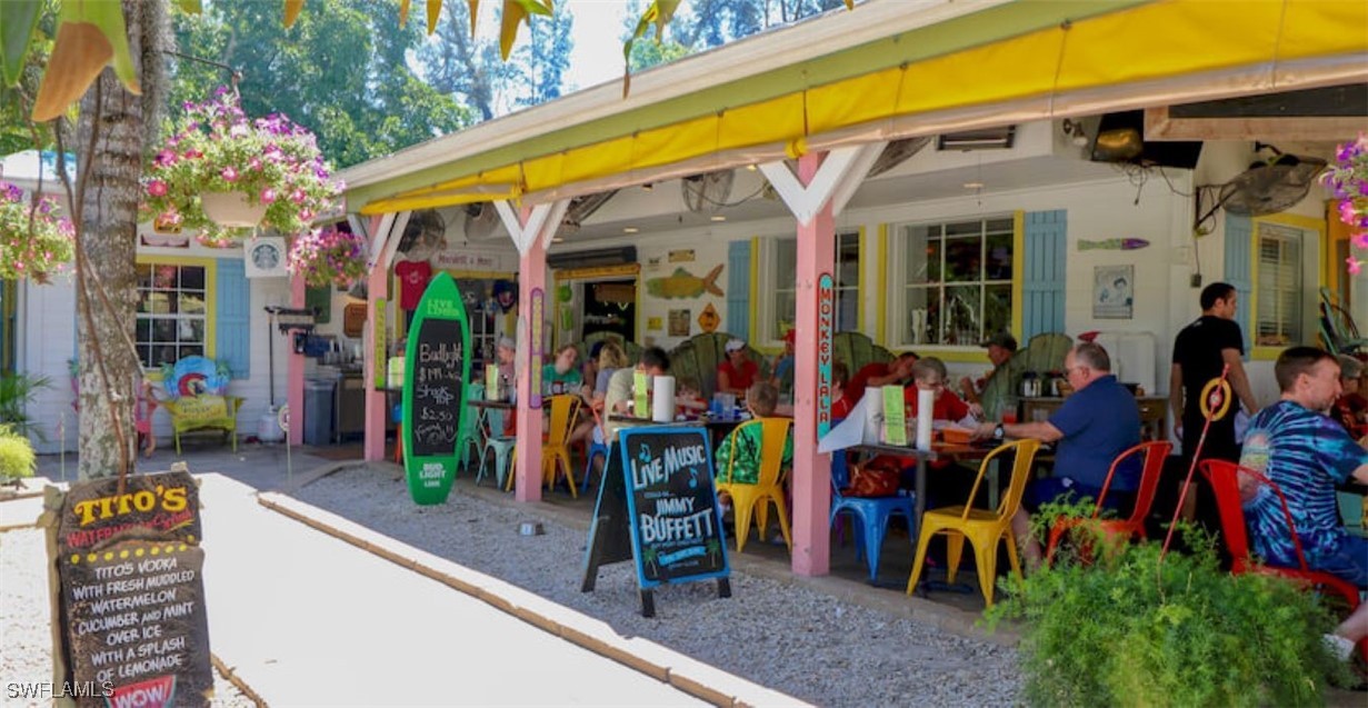2163-2153 Periwinkle Way Sanibel, FL 33957 - Photo 20 of 37 a view of people sitting in front of retail shops