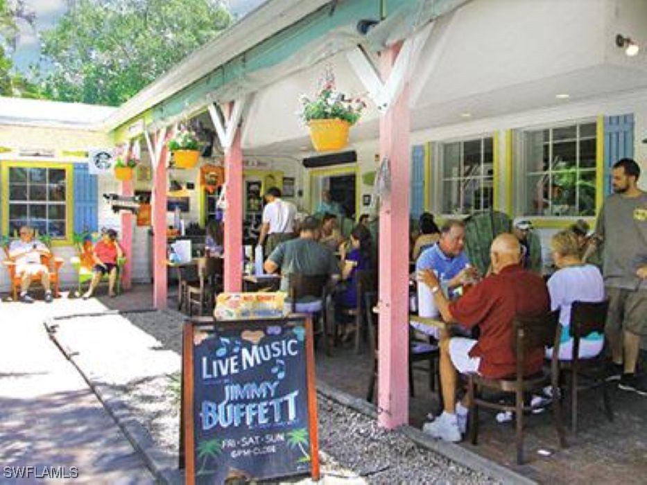 2163-2153 Periwinkle Way Sanibel, FL 33957 - Photo 21 of 37 a group of people sitting outside of a building