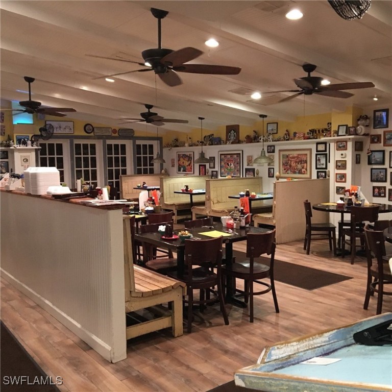 2163-2153 Periwinkle Way Sanibel, FL 33957 - Photo 25 of 37 a kitchen with stainless steel appliances kitchen island granite countertop a table and chairs in it