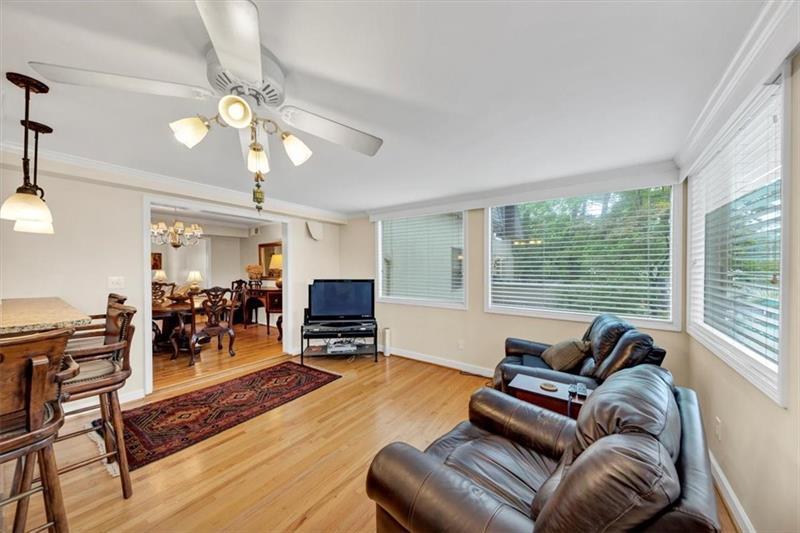 30 Chaumont Square Northwest Atlanta, GA 30327 - Photo 13 of 44 a living room with furniture a chandelier and a flat screen tv