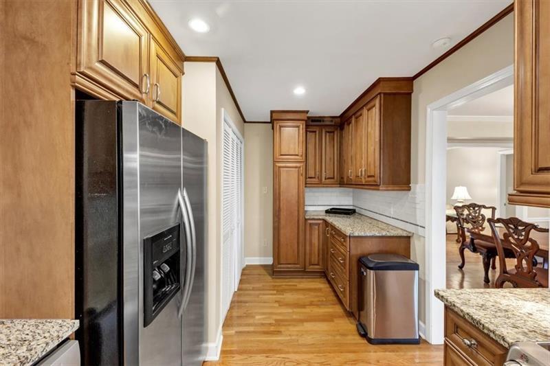 30 Chaumont Square Northwest Atlanta, GA 30327 - Photo 18 of 44 a kitchen with granite countertop a refrigerator a stove and a sink