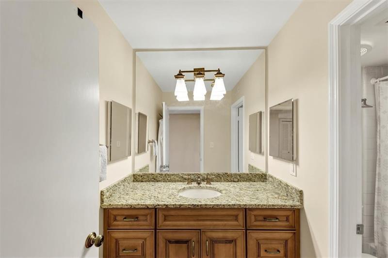 30 Chaumont Square Northwest Atlanta, GA 30327 - Photo 19 of 44 a bathroom with a granite countertop sink and a mirror