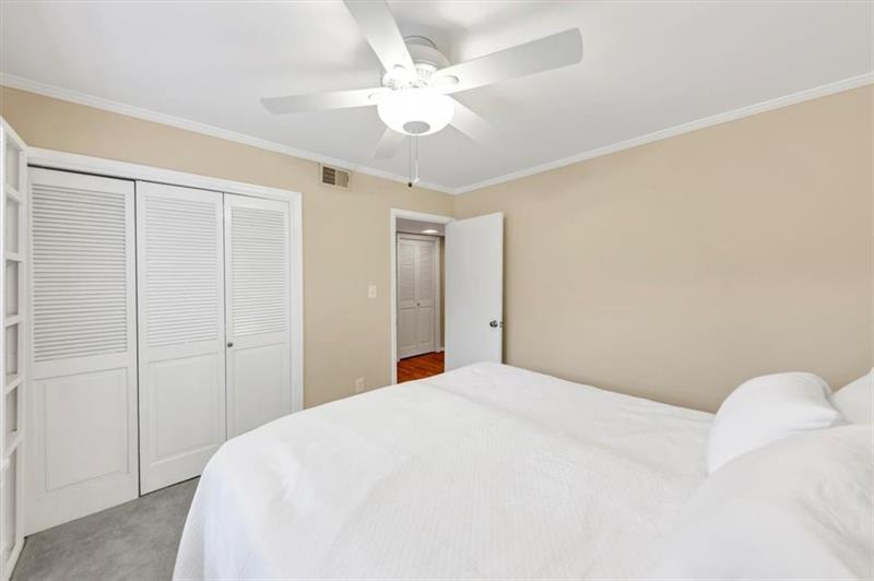 30 Chaumont Square Northwest Atlanta, GA 30327 - Photo 22 of 44 a bedroom with a bed and a ceiling fan