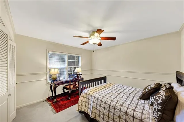 a bedroom with furniture and a large window
