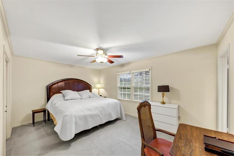 30 Chaumont Square Northwest Atlanta, GA 30327 - Photo 25 of 44 a bedroom with a bed chair and a window