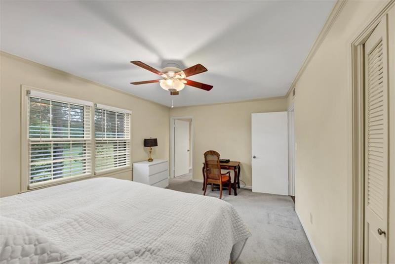 30 Chaumont Square Northwest Atlanta, GA 30327 - Photo 27 of 44 a bedroom with furniture and large windows