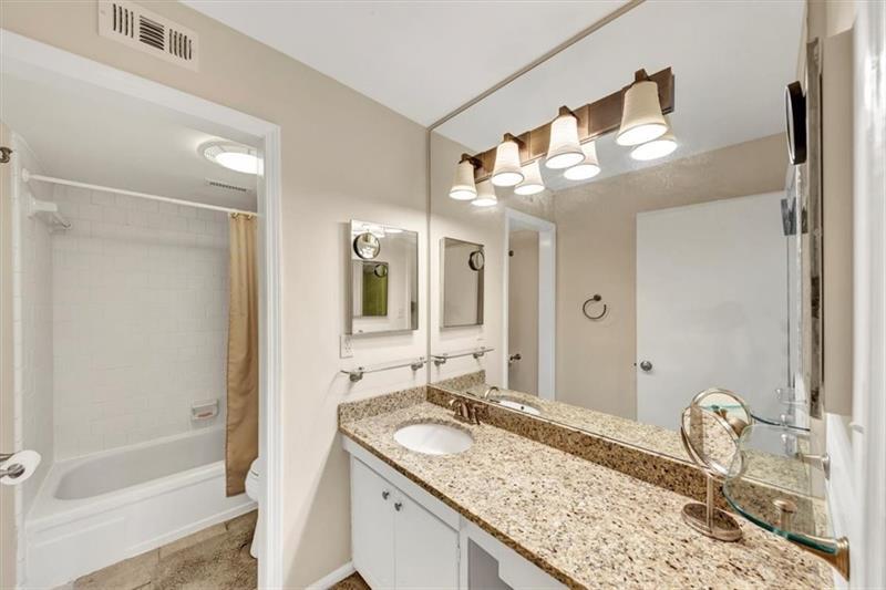 30 Chaumont Square Northwest Atlanta, GA 30327 - Photo 28 of 44 a bathroom with a granite countertop sink and a mirror