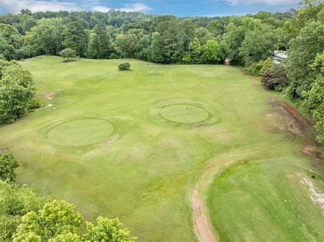 an aerial view of a house with a yard and lake view