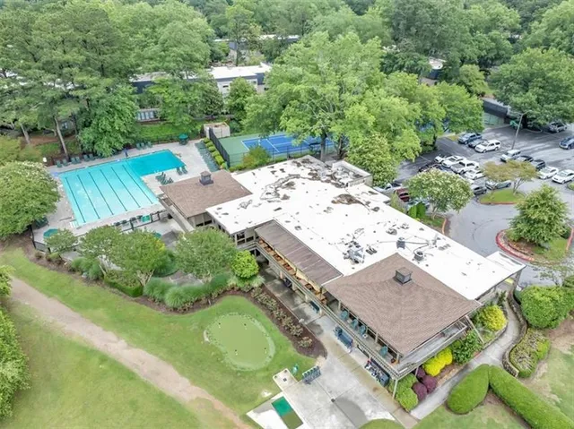 an aerial view of a houses with a yard and lake view