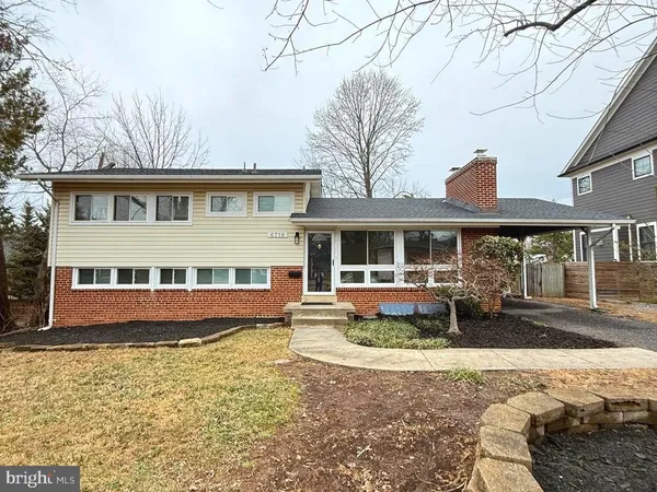 a front view of a house with swimming pool and glass windows