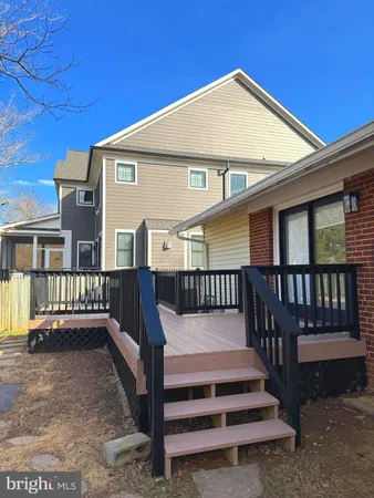 a view of a house with wooden fence