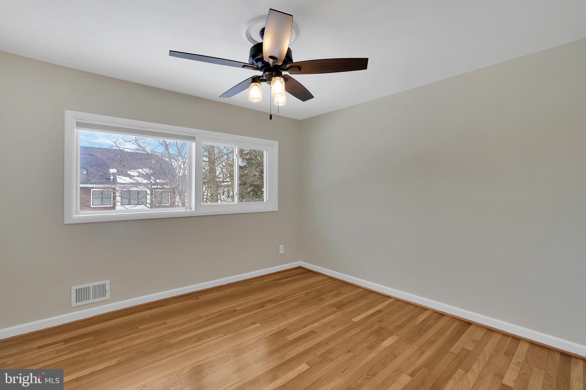6718 Old Chesterbrook Road McLean, VA 22101 - Photo 7 of 38 a view of empty room with wooden floor and fan