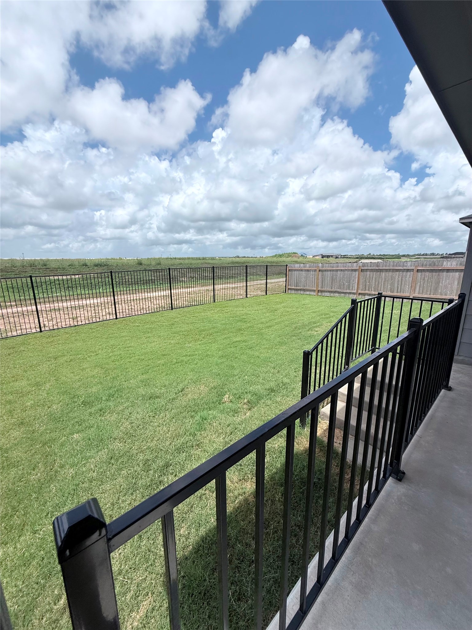 192 Rodney Boat Road Kyle, TX 78640 - Photo 3 of 40 A spacious, verdant yard awaits outdoor enjoyment, bordered by secure fencing and open views.