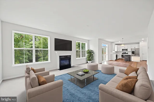 a view of empty room with a fireplace and windows