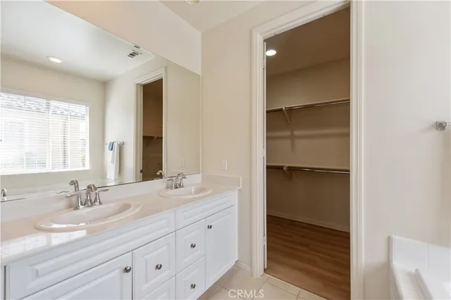 a bathroom with a double vanity sink and mirror