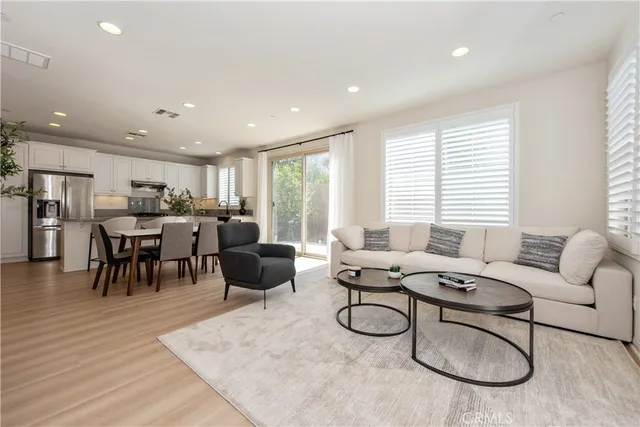 a living room with furniture windows and a table