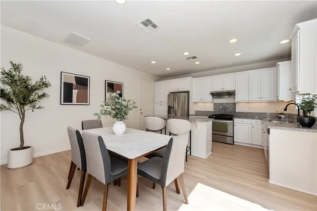 a kitchen with a table and chairs in it
