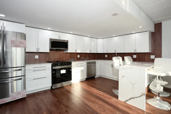 a kitchen with a refrigerator stove top oven and sink
