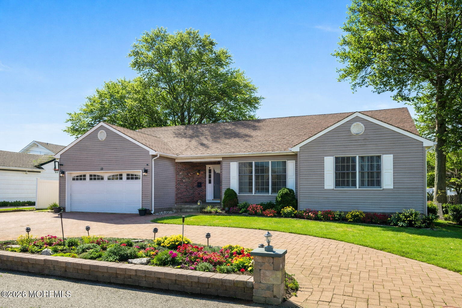 a front view of a house with a garden