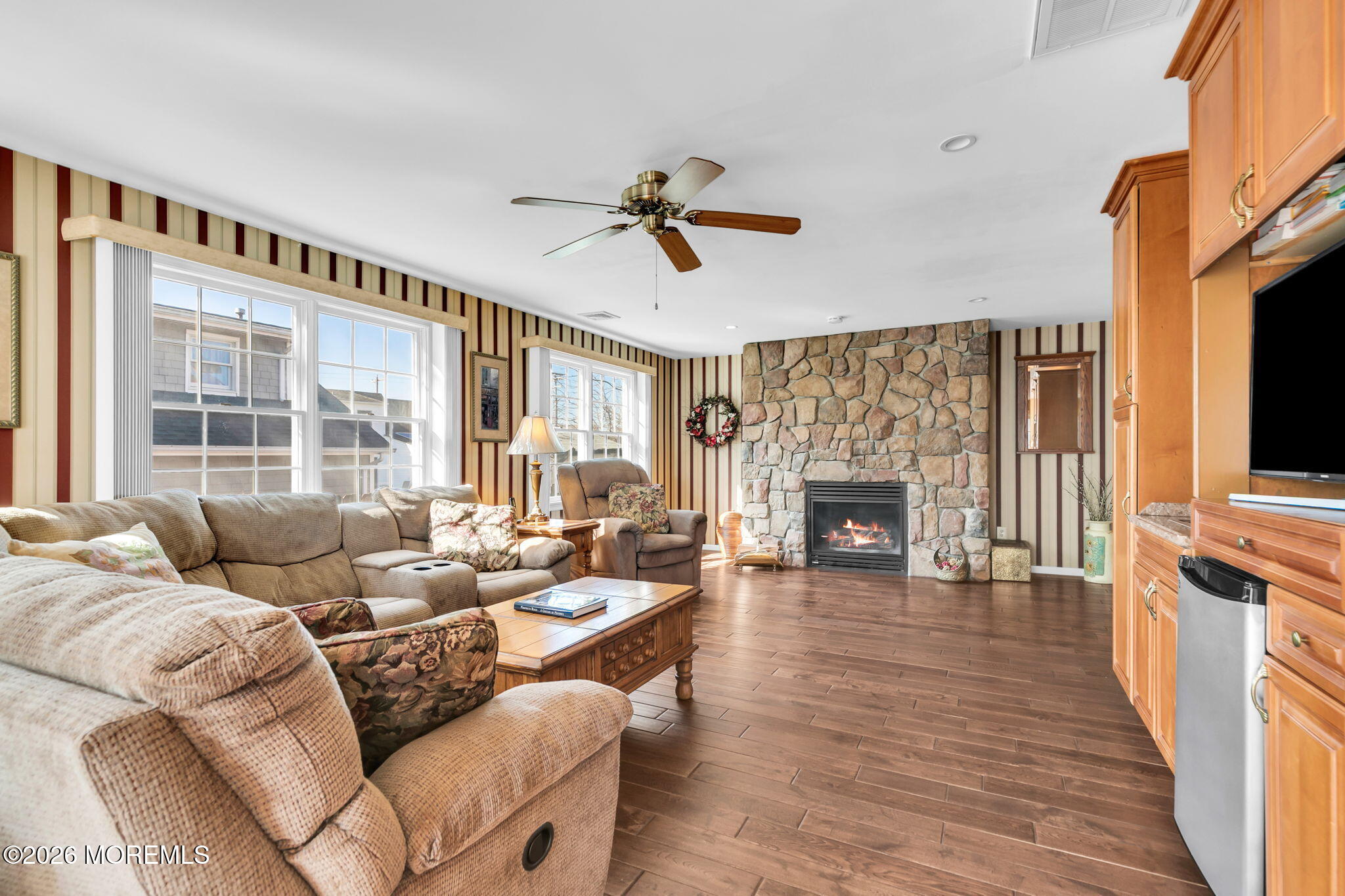 12 S Road Monmouth Beach, NJ 07750 - Photo 4 of 19 a living room with furniture a fireplace and a flat screen tv