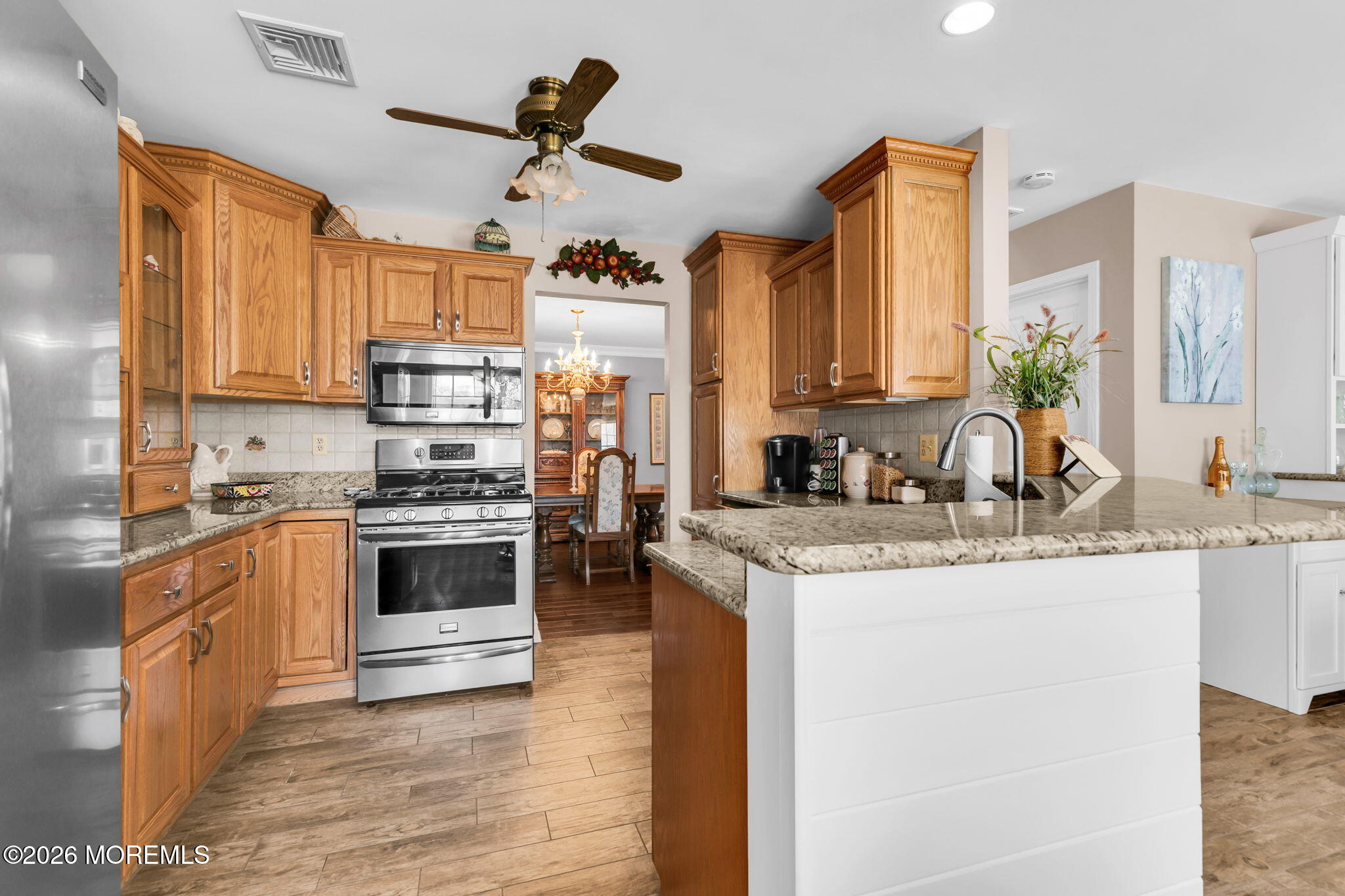 12 S Road Monmouth Beach, NJ 07750 - Photo 5 of 19 a kitchen with stainless steel appliances granite countertop a sink a stove and a refrigerator