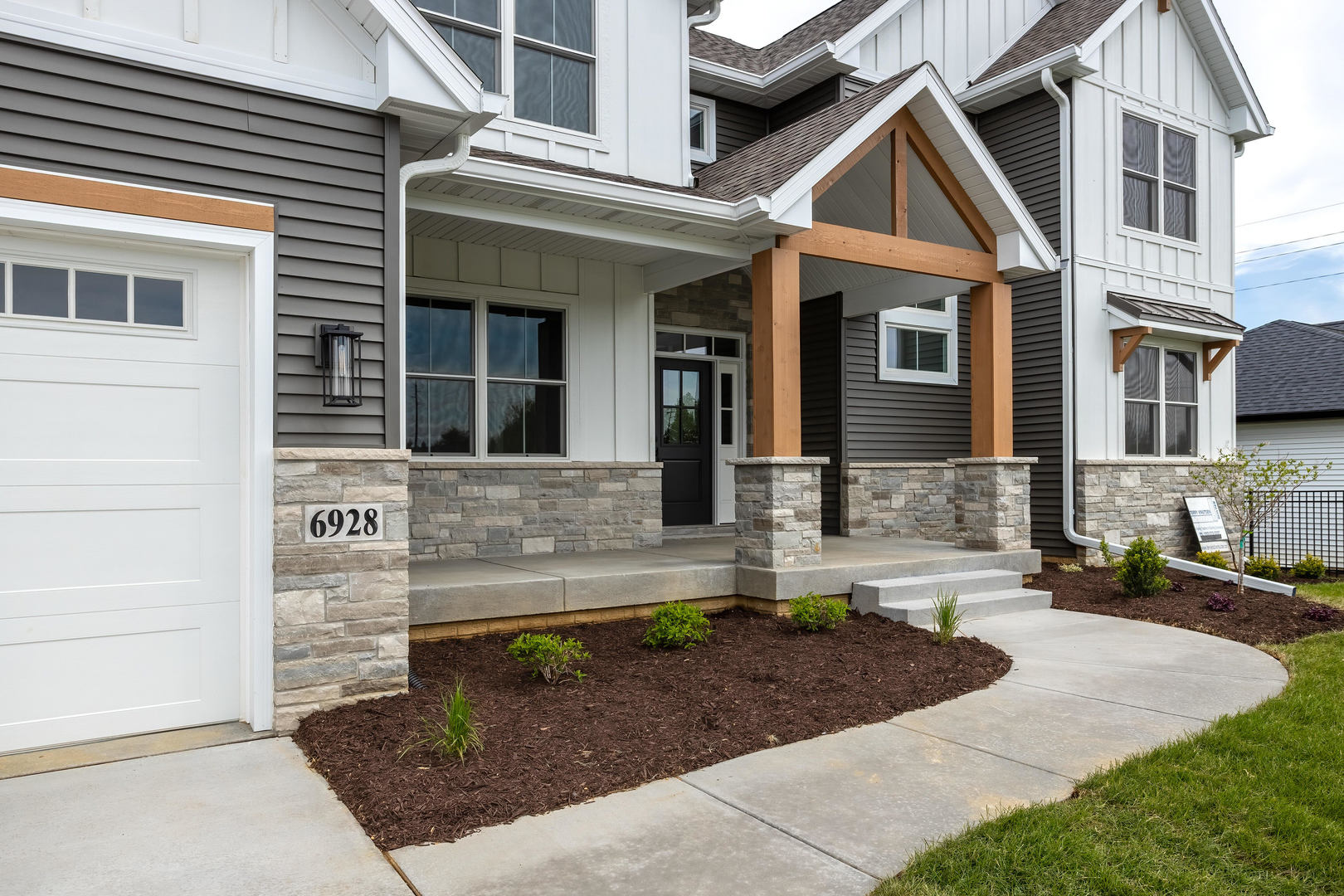 6928 Wilderness Pointe Bettendorf, IA 52722 - Photo 2 of 48 a front view of a house with garden