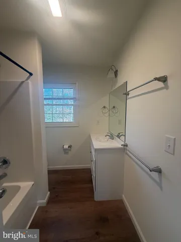 a view of a storage & utility room with fridge