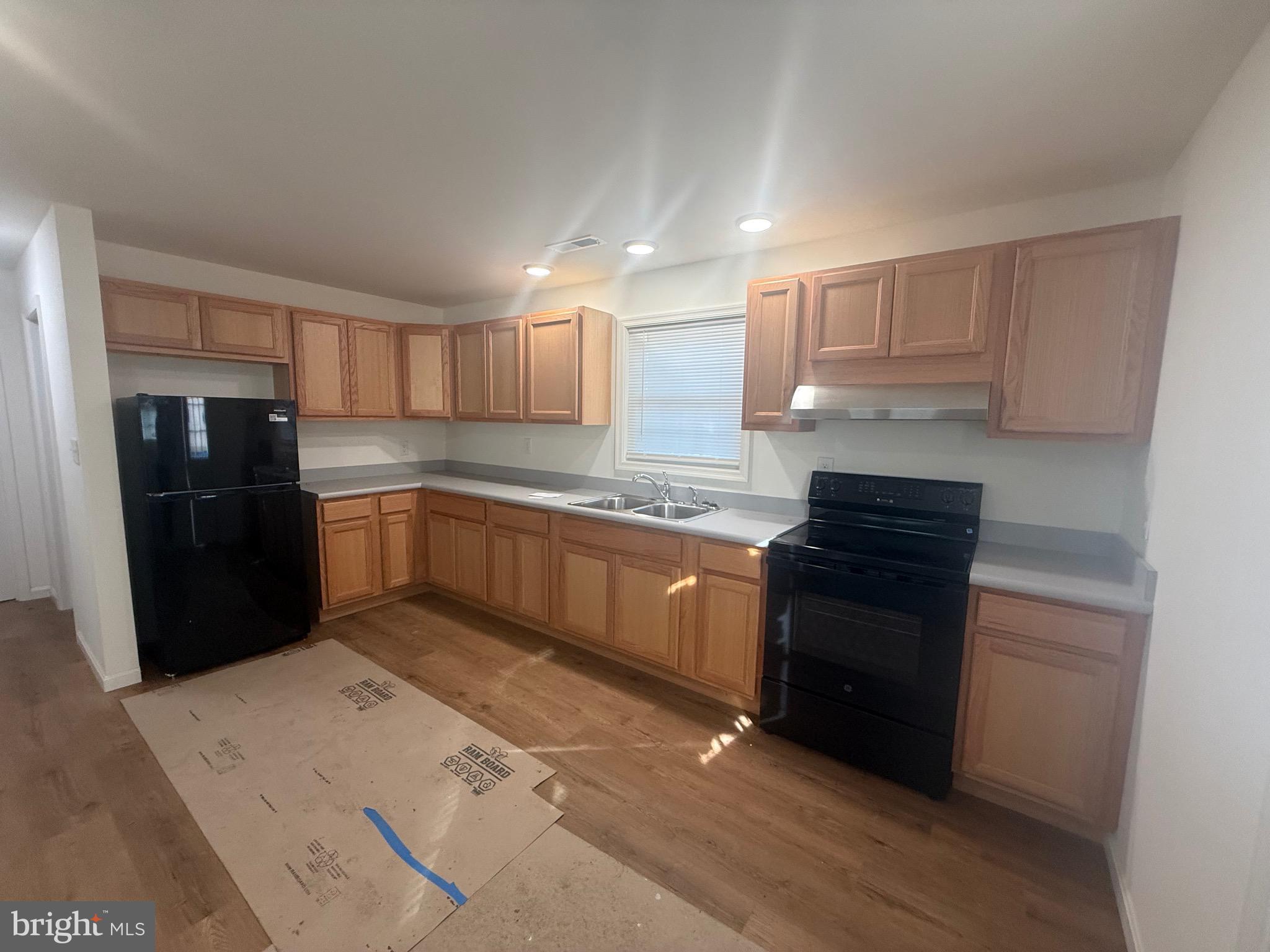 8859 Clendaniel Pond Road Lincoln, DE 19960 - Photo 10 of 25 a kitchen with granite countertop a refrigerator stove top oven and sink