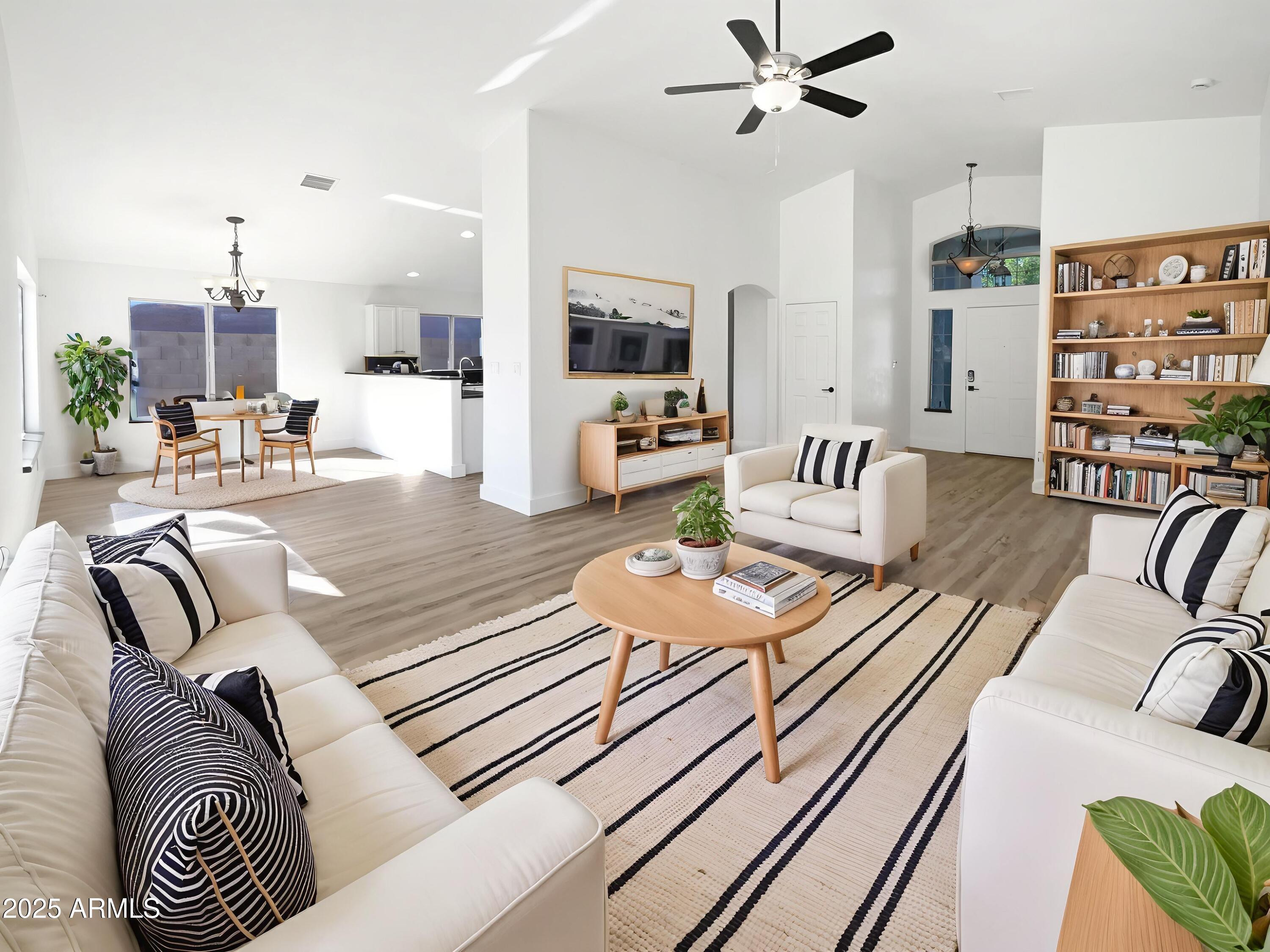 317 East Nunneley Road Gilbert, AZ 85296 - Photo 2 of 27 a living room with furniture and wooden floor