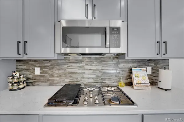 a kitchen with a stove and cabinets