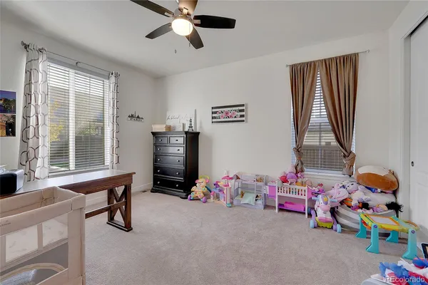 a bedroom with toys and a window