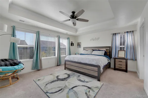 a spacious bedroom with a bed and a window