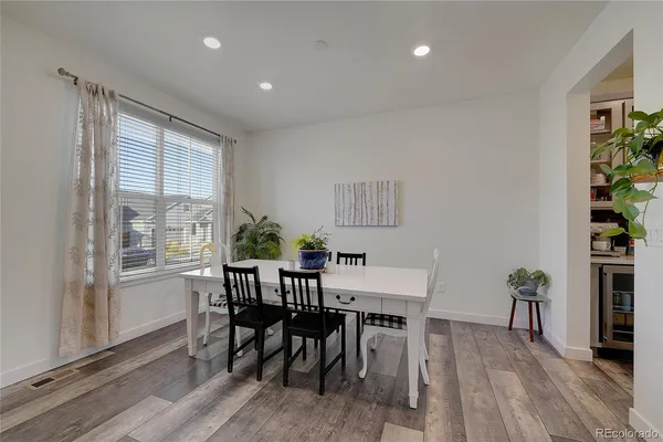a view of a dining room with furniture window and wooden floor