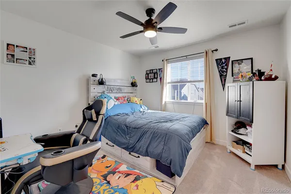 a bedroom with furniture and a window