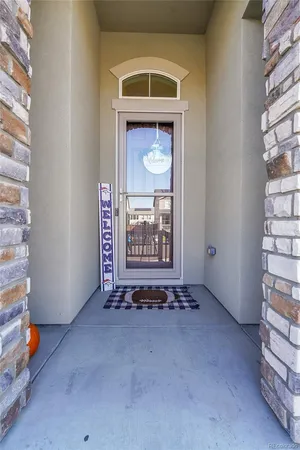 a view of an empty room with a fireplace and window