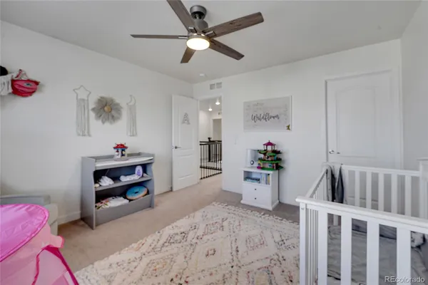 a living room with furniture and baby bed